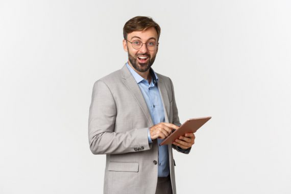 portrait-happy-surprised-bearded-businessman-grey-suit-glasses-holding-digital-tablet تاثیر هوش هیجانی در ارتباطات سازمانی